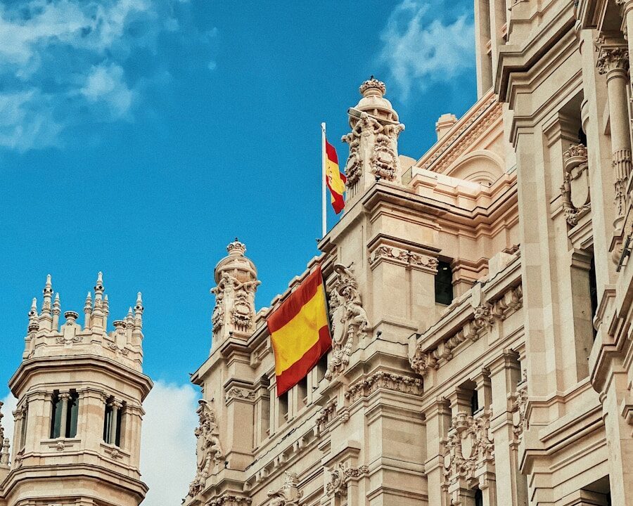 yellow and red flag hanging on white building