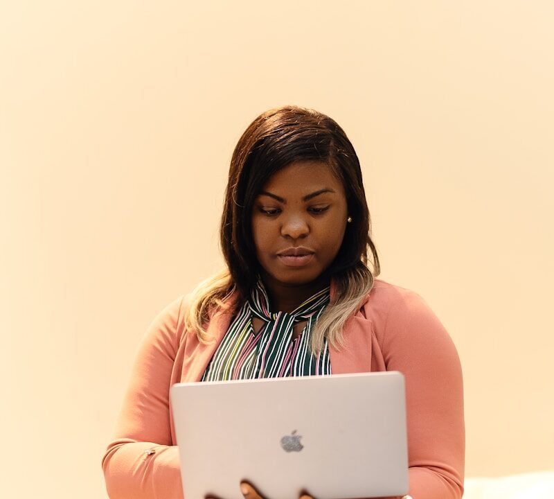 African creator typing on a laptop, illustrating AI-assisted content and copyright ownership questions in Kenya