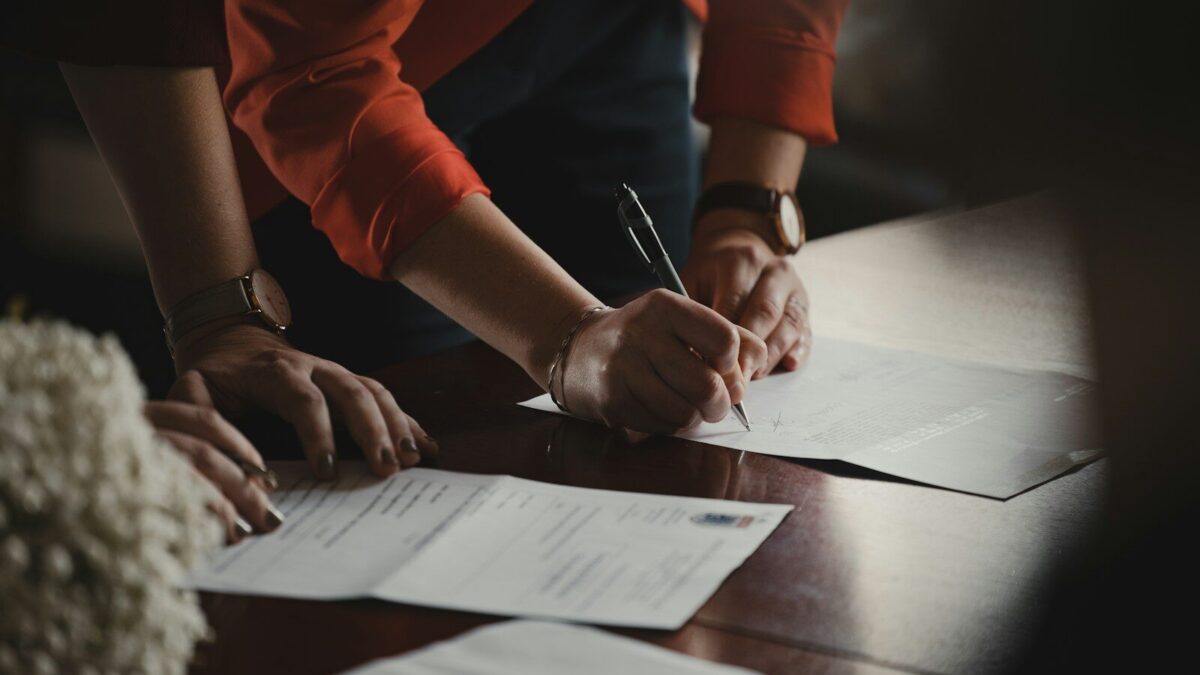African business executive signing a share buyback agreement