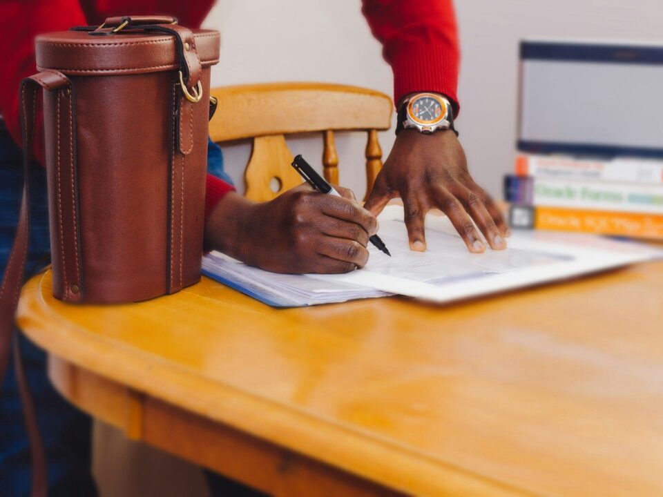 African professional reviewing bribery act compliance documents
