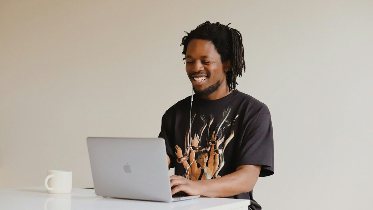 African professional using a laptop, representing a business handling domain name disputes in Kenya