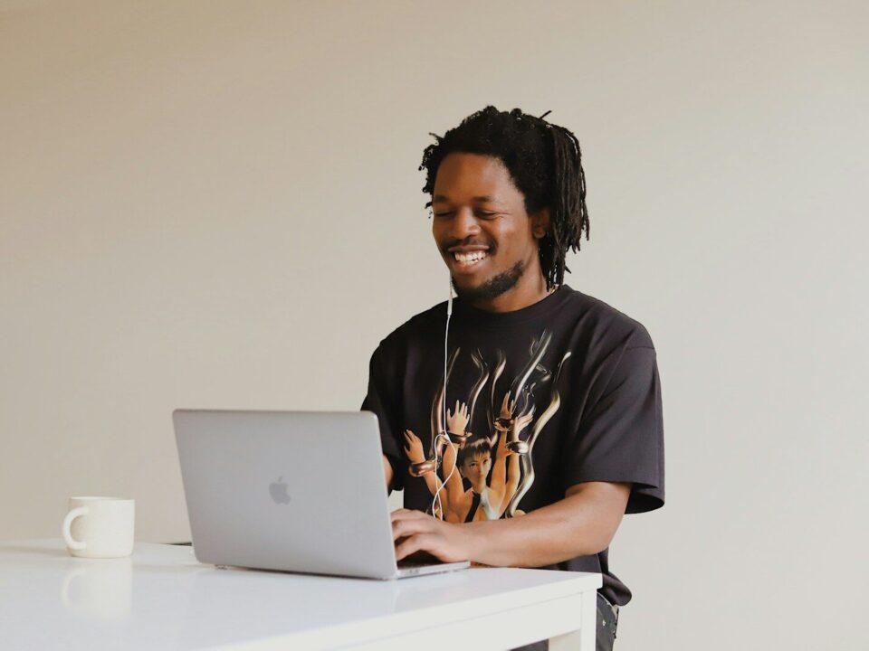 African professional using a laptop, representing a business handling domain name disputes in Kenya