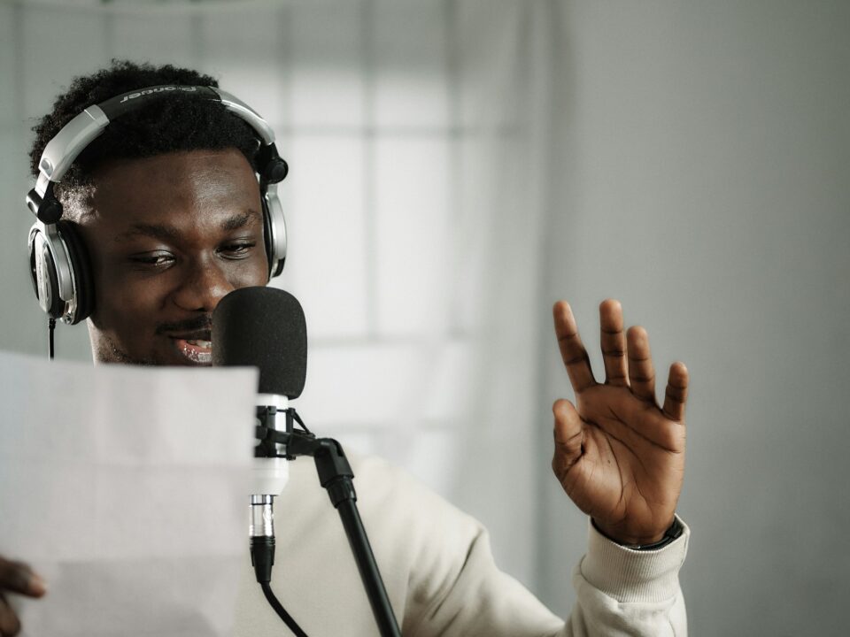 African broadcaster recording at a microphone, representing broadcasting and neighbouring rights