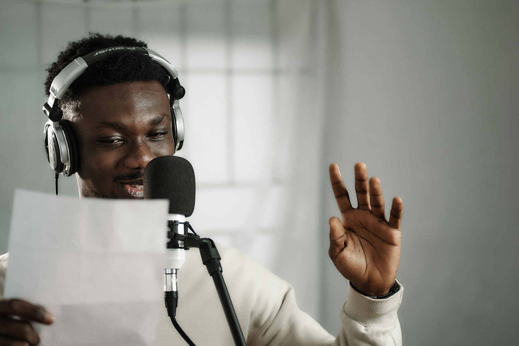 African broadcaster recording at a microphone, representing broadcasting and neighbouring rights