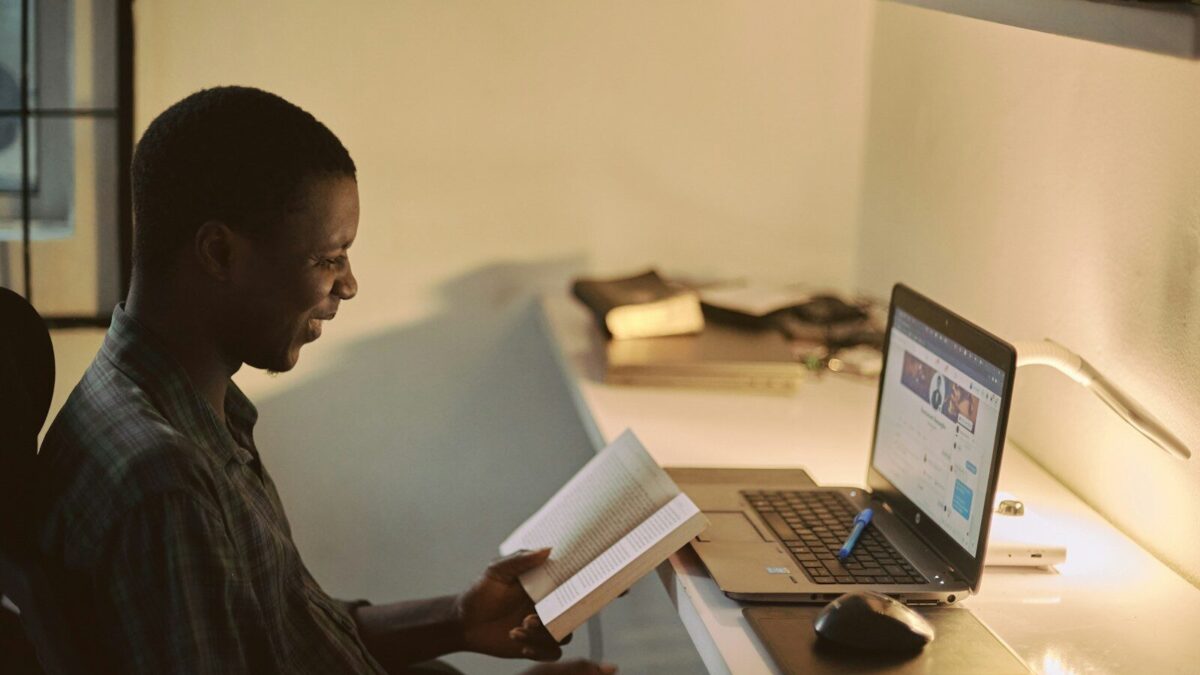 African professional at a laptop preparing board resolutions