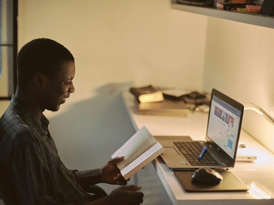 African professional at a laptop preparing board resolutions
