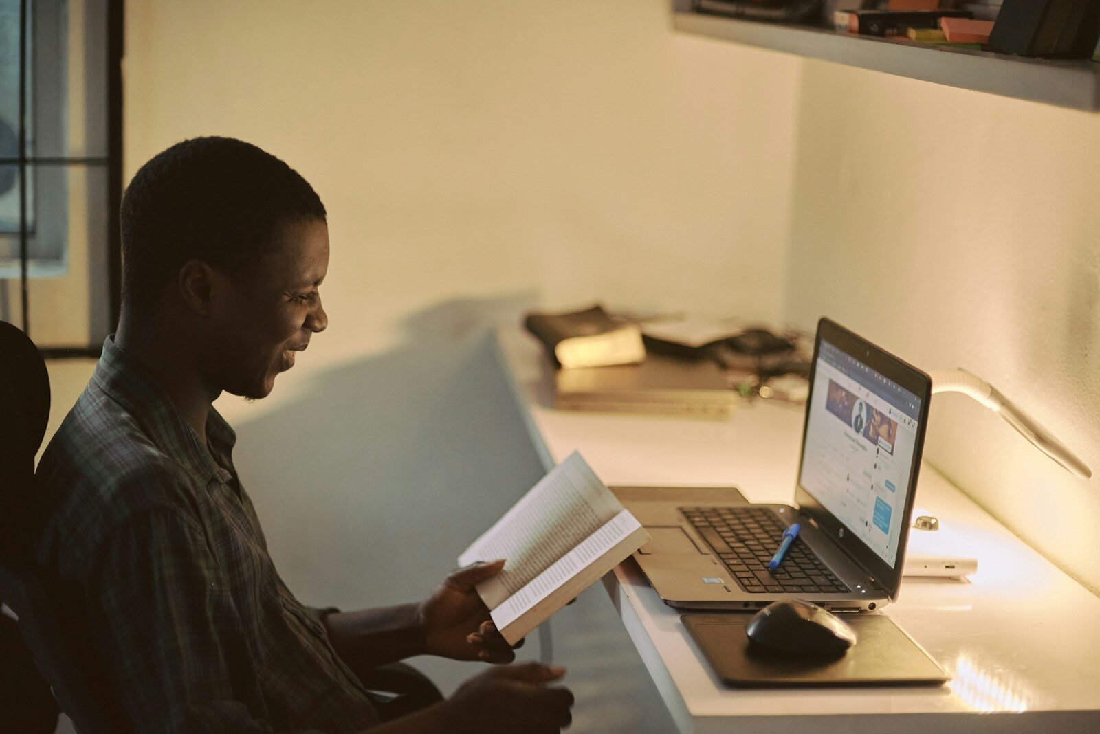 African professional at a laptop preparing board resolutions