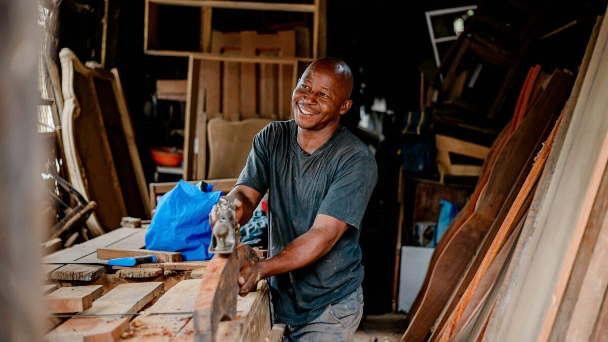African craftsman working on a piece of wood, representing industrial designs Kenya law protects under the Industrial Property Act