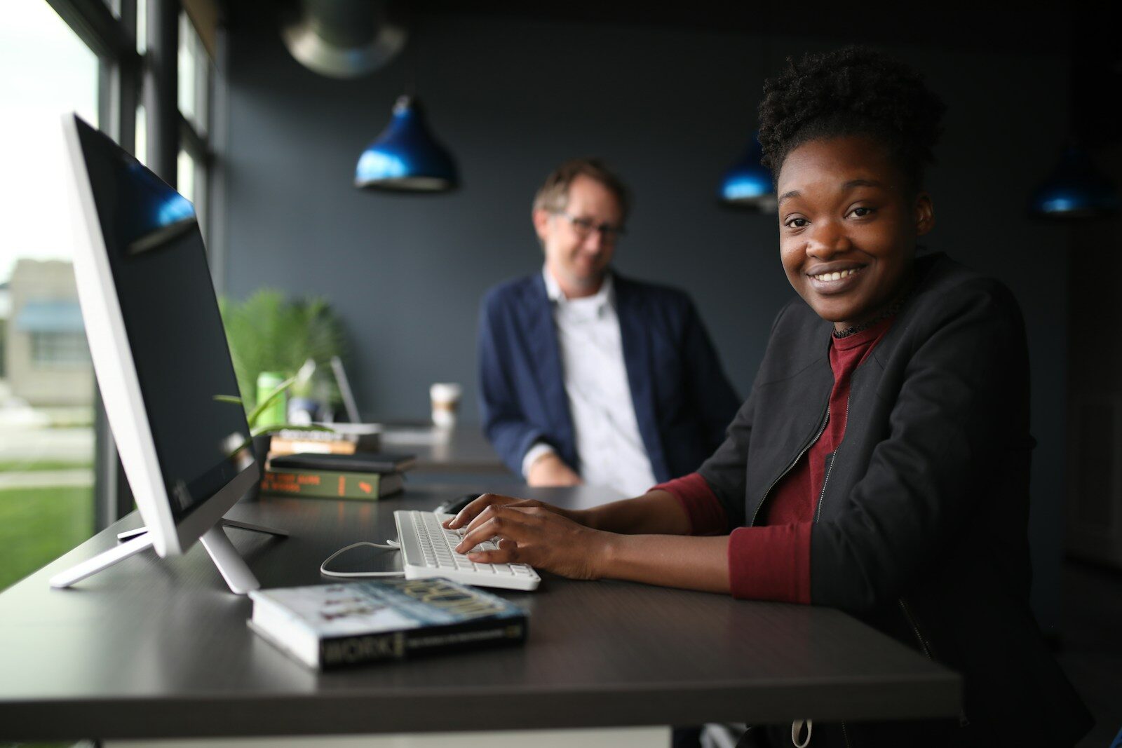Two professionals reviewing documents at a desk, illustrating local agent requirements in Kenya for a foreign IP applicant filing at KIPI