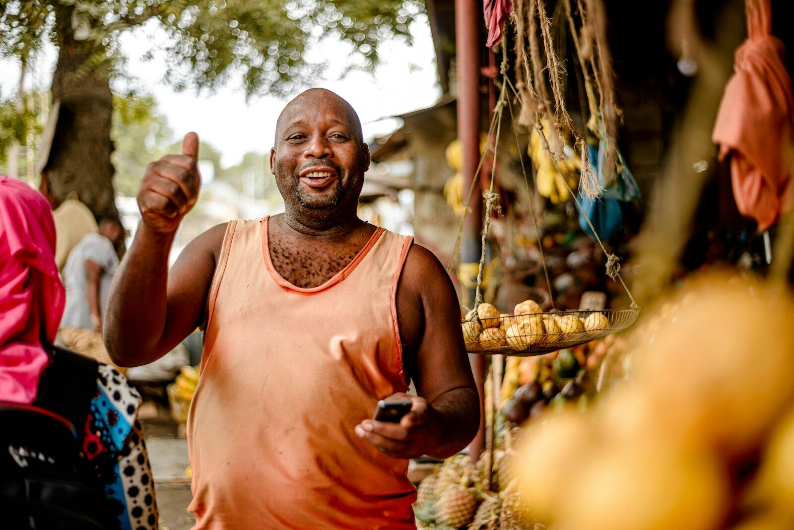 African market vendor at a fruit stand, representing goods the Anti-Counterfeit Authority Kenya relies on works to protect