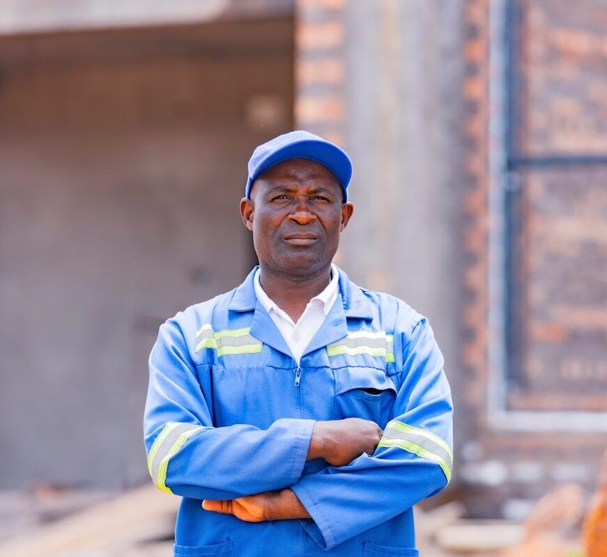 Technician in blue coveralls at a solar installation site in Kenya