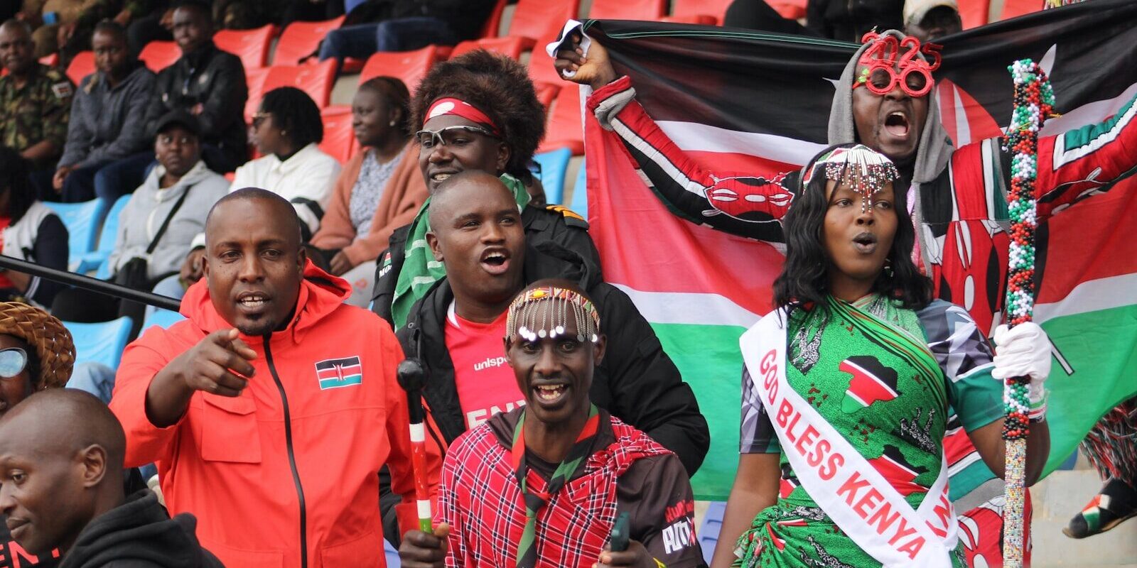 Kenyan football fans celebrating in a packed stadium