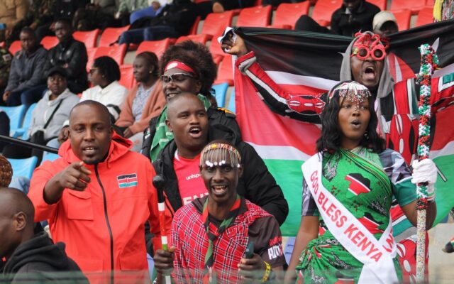 Kenyan football fans celebrating in a packed stadium