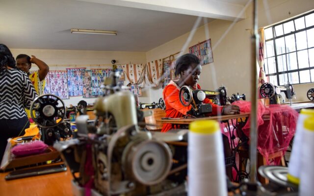 Workers operating sewing machines in an African garment factory, representing process know-how and trade secrets in Kenyan manufacturing