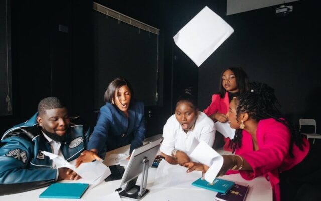 African marketing team planning an advertising campaign around a table