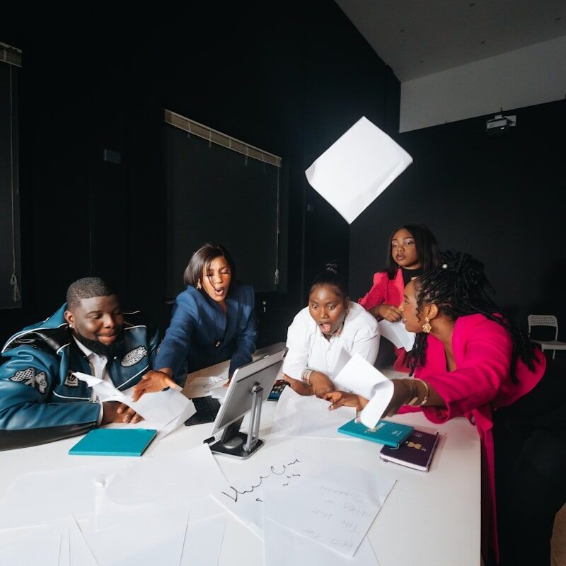 African marketing team planning an advertising campaign around a table