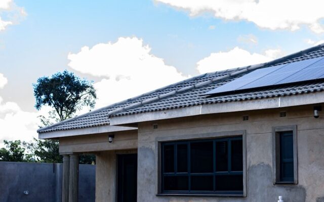 House under construction with solar panels installed on the roof in Kenya