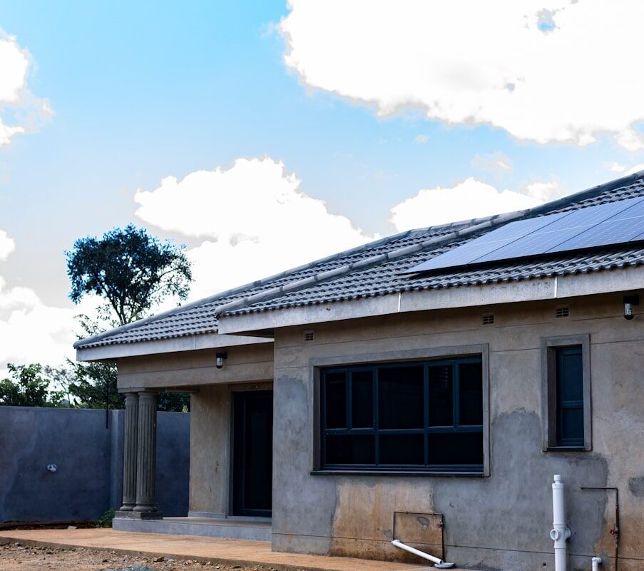 House under construction with solar panels installed on the roof in Kenya