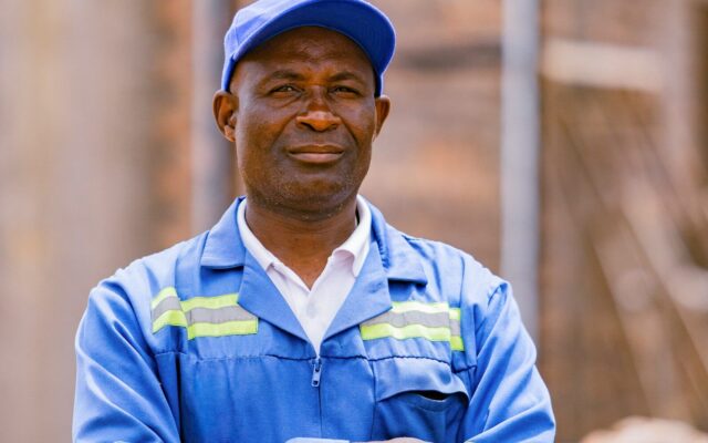 An African factory worker at a manufacturing plant, representing the kind of pharmaceutical manufacturing operations eligible for SEZ or EPZ status in Kenya