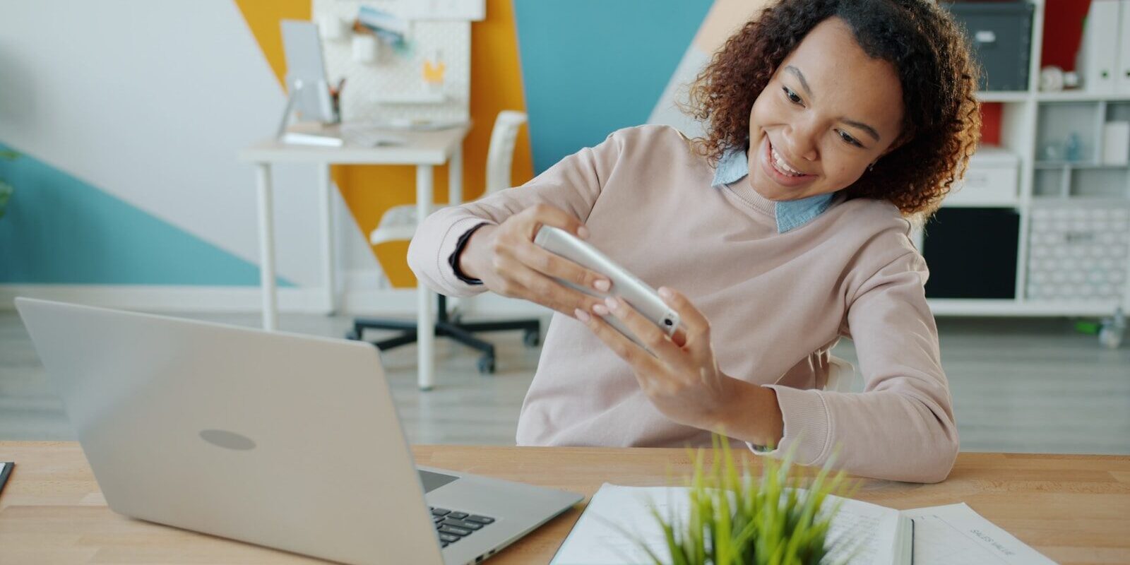 A Kenyan professional using a mobile insurtech app on a smartphone in an office setting