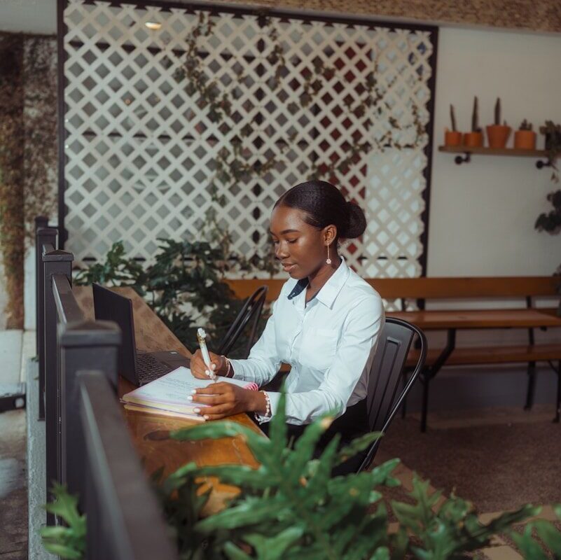 African professional reviewing licence application documents at a desk