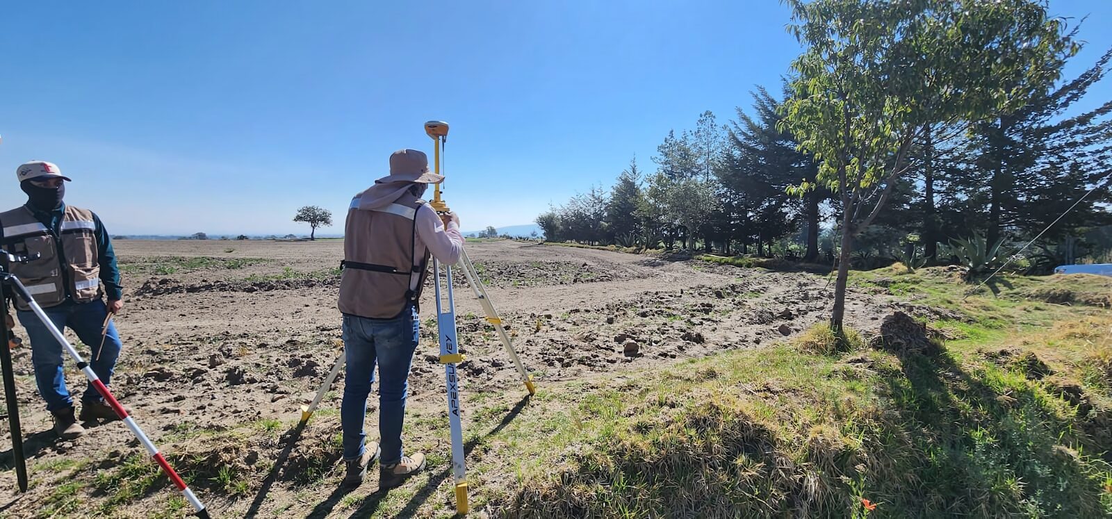 African land surveyor using a theodolite to survey rural land in Kenya