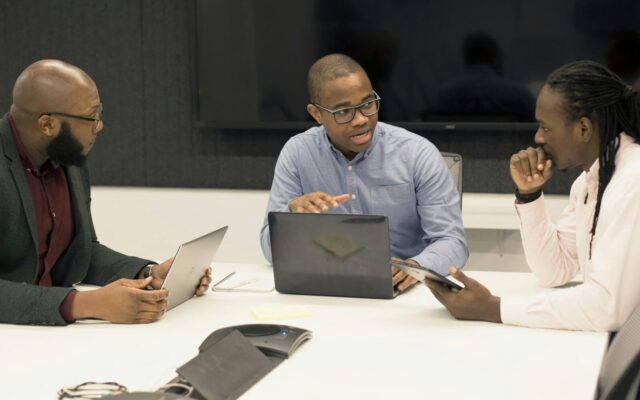 Sports federation officials reviewing compliance documents together