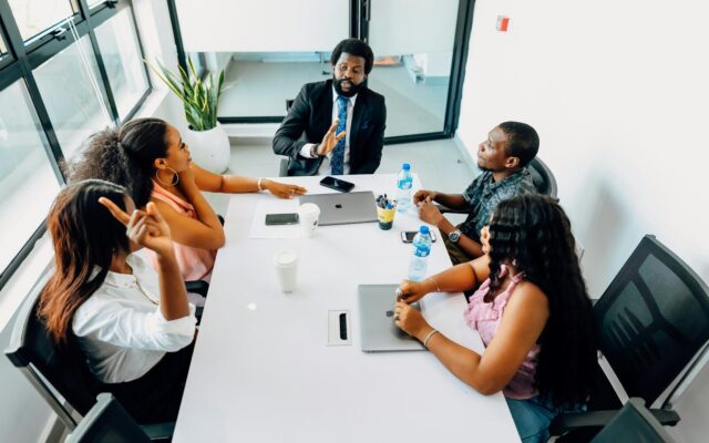 African business team in a boardroom meeting discussing compliance