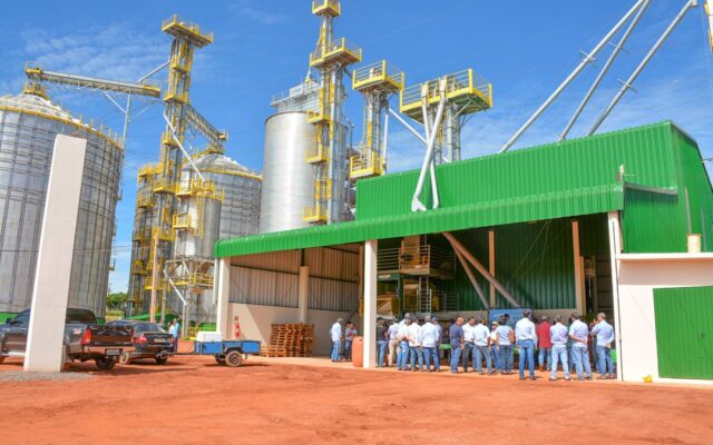 Agro-processing facility with silos and staff outside
