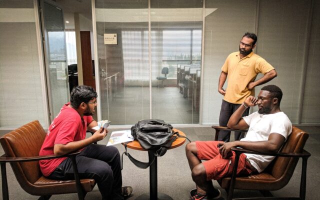 Factory workers in discussion at a manufacturing plant