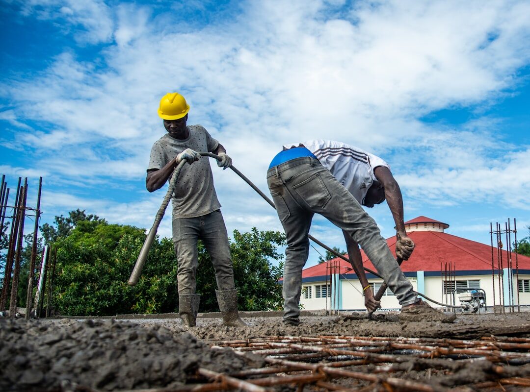 Construction workers pouring concrete on a building site in Kenya