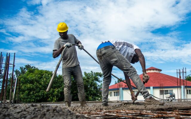 Construction workers pouring concrete on a building site in Kenya