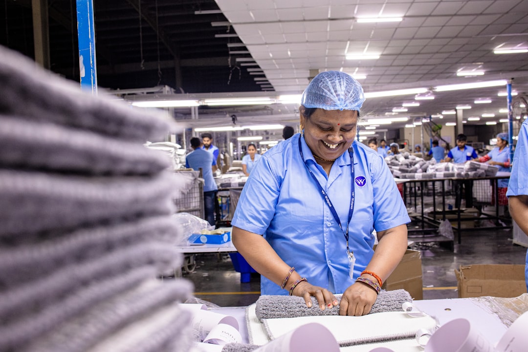 Factory worker folding finished textile products