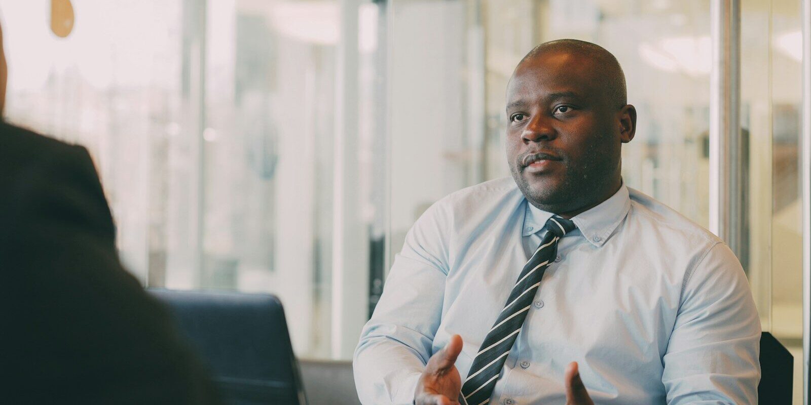 Professional explaining options in a meeting, illustrating the resolution of trust and trustee disputes under Kenyan law