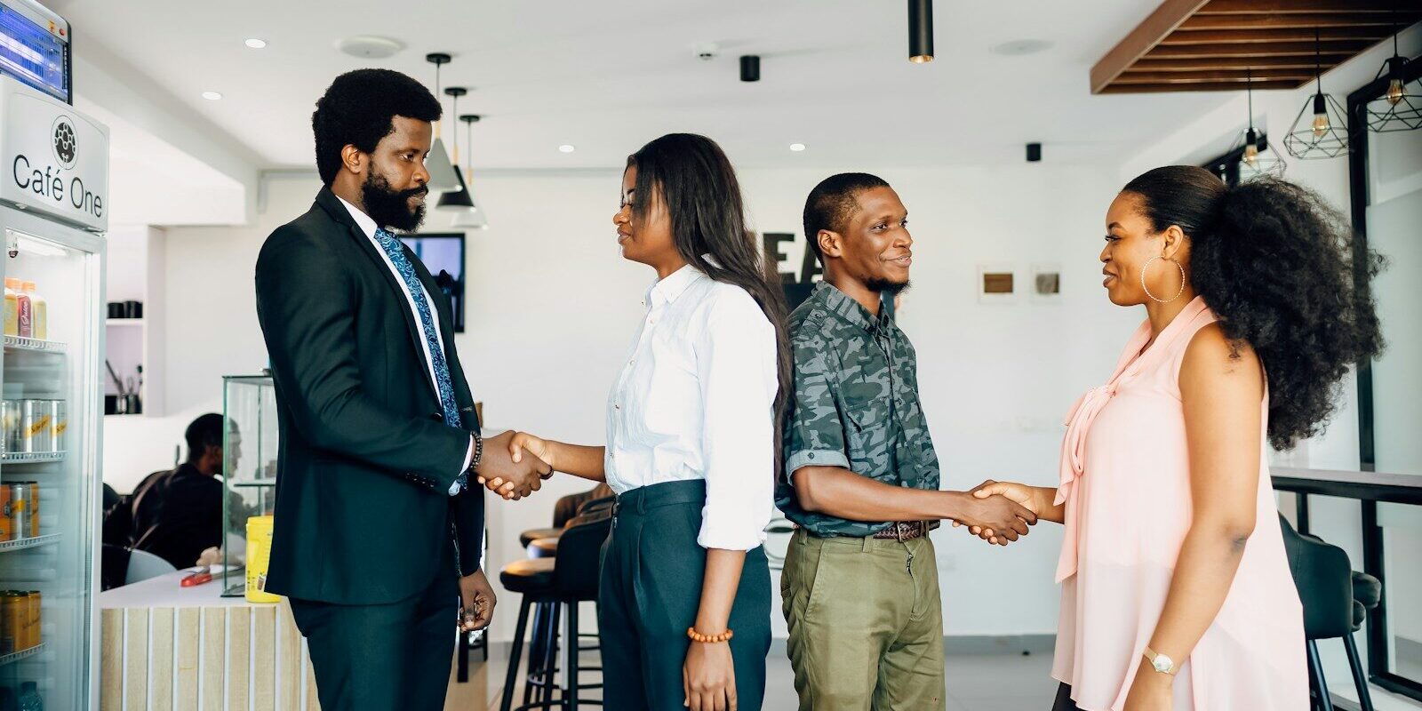 African business team shaking hands after finalizing a healthcare sector acquisition deal in Kenya
