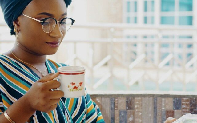 Woman reviewing papers over tea, illustrating an independent enforcer monitoring trustees under Kenyan trust law