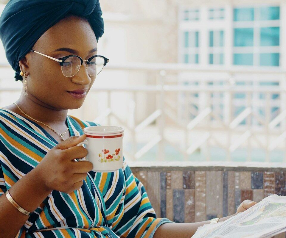 Woman reviewing papers over tea, illustrating an independent enforcer monitoring trustees under Kenyan trust law