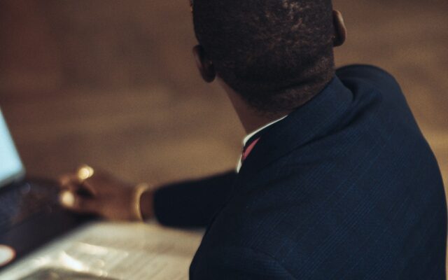 African compliance professional reviewing records on a laptop, representing AML and Travel Rule compliance for Kenya VASPs