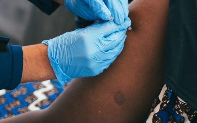 Health worker administering a vaccination to a patient in Africa, relevant to African Medicines Agency product registration
