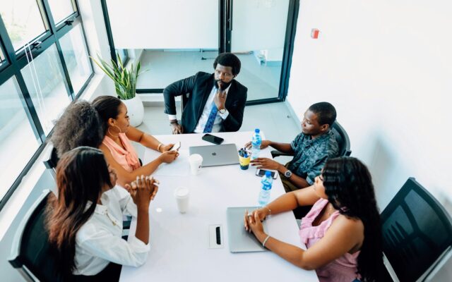 African business team negotiating a supply contract in a meeting room, discussing arbitration clause terms