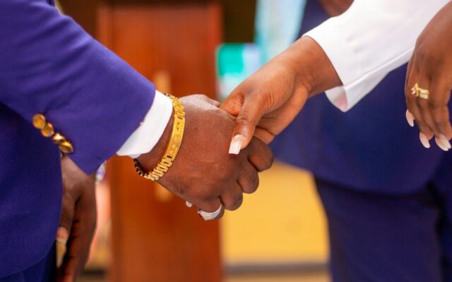 Two people shaking hands on an agreement, illustrating a security trustee arrangement in a Kenyan lending transaction