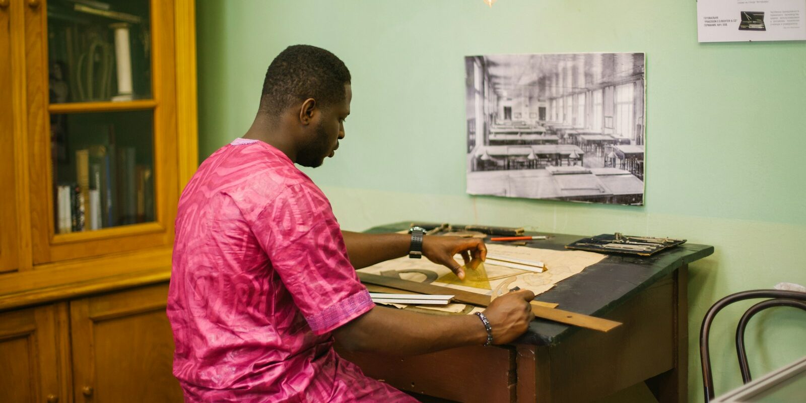 90-day regularisation: an African business owner at a desk putting permits and licences in order