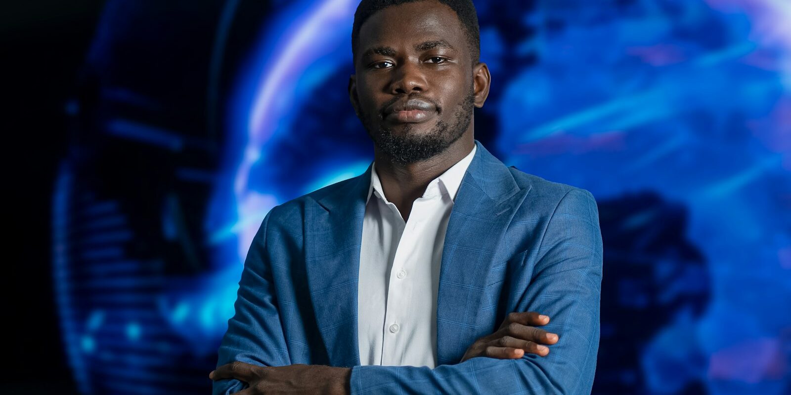 Freezing and seizure orders: an African technology professional in a blue blazer before a digital globe backdrop