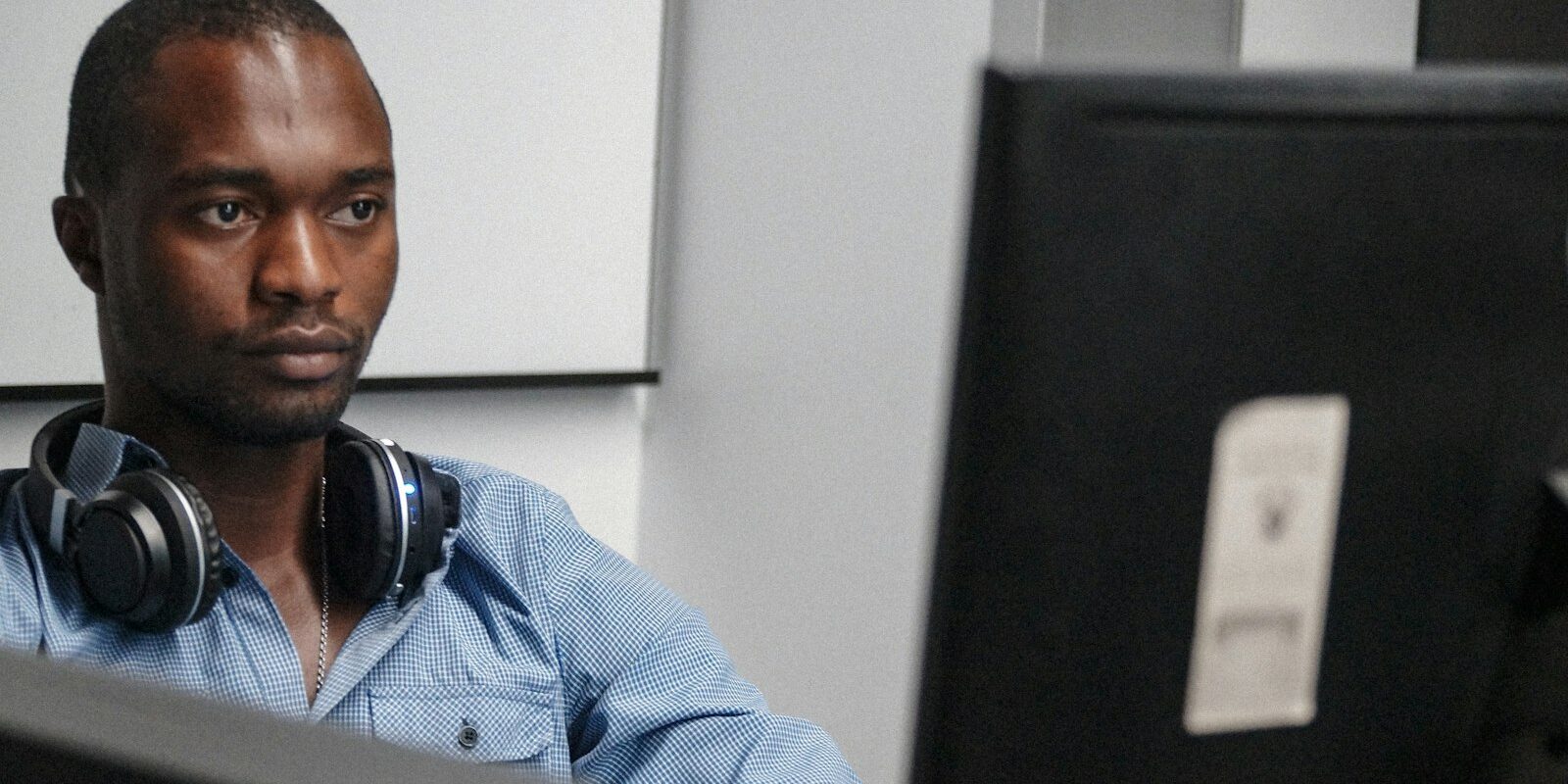 Kenyan tech professional reviewing legislation on a computer screen