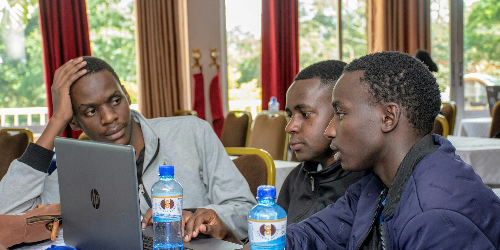Group of African professionals reviewing technology policy on a laptop