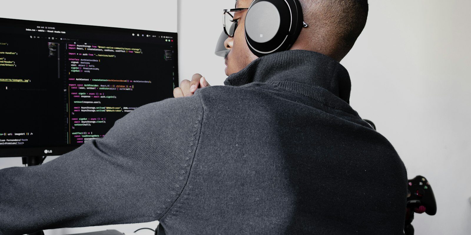 African software developer working at a dual-monitor coding setup