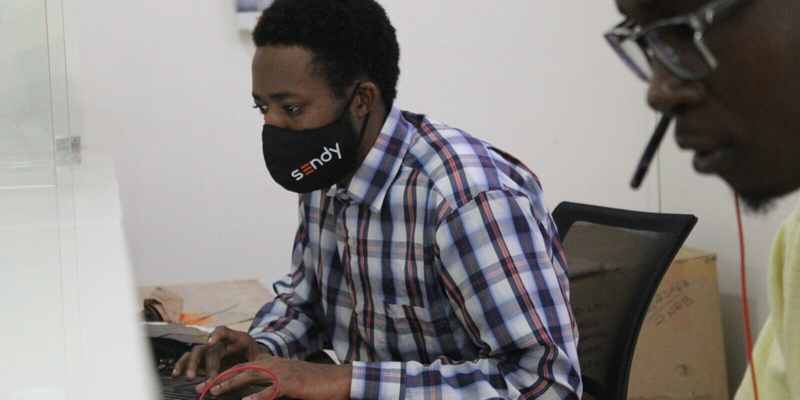 Kenyan office employee at a desk during a probationary work period