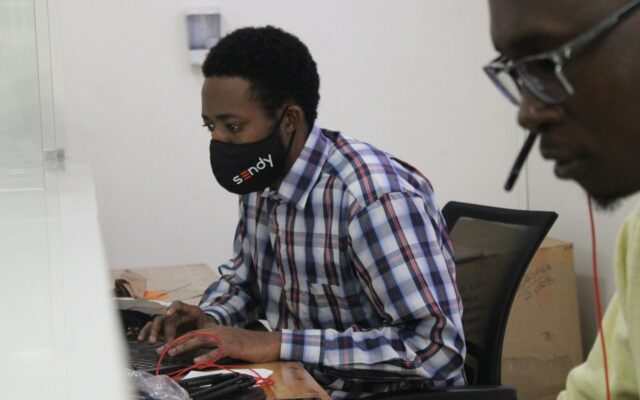 Kenyan office employee at a desk during a probationary work period
