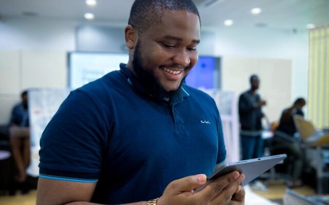 Stablecoin Issuance Kenya — African fintech professional reviewing a digital currency platform on a tablet