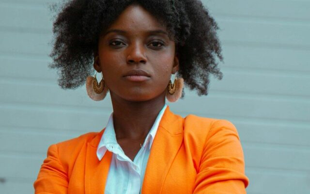 Trademark renewal in Kenya: African businesswoman in an orange blazer representing a trademark owner